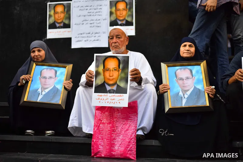 Relatives and friends of Egyptian journalist Tamer Abdel Raouf, hold his pictures during a protest marking the second anniversary of his death, in front of the journalists' syndicate in Cairo on August 19, 2015. Tamer Ab...