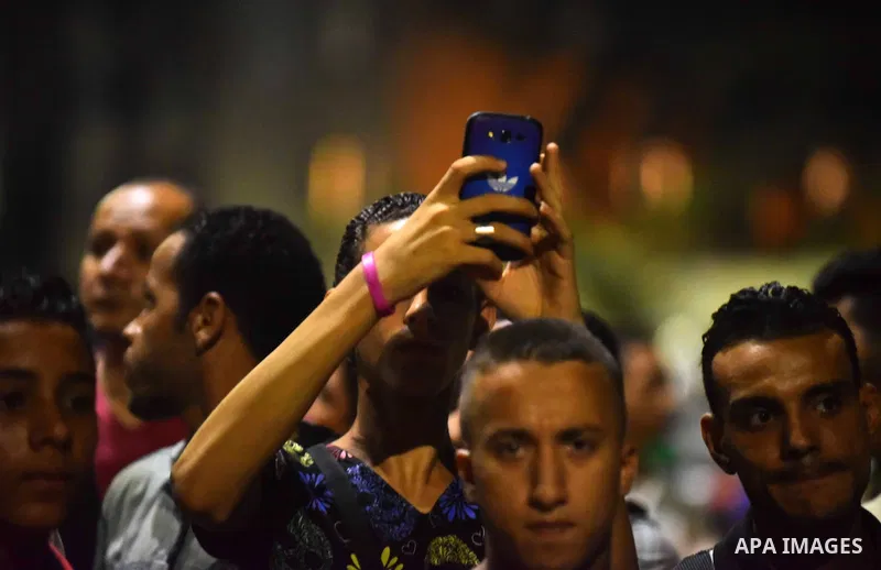 Egyptians gather near the site of a bomb blast at a national security building in Shubra El-Kheima, Qaliubiya Governorate, on the outskirts of Cairo, Egypt August 20, 2015. At least six people were wounded early on Thurs...