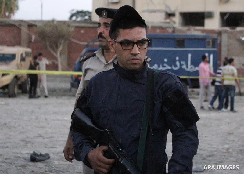 Egyptian policemen stand guard in front of a damaged national security building after a bomb blast in the district of Shubra El-Kheima, Qaliubiya Governorate, Egypt, Aug. 20, 2015. At least six people were wounded early...