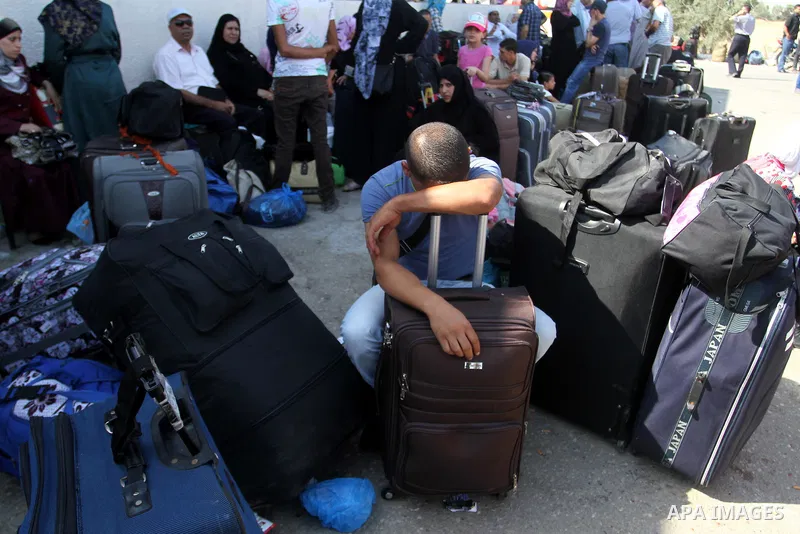 Palestinians gather at the Rafah border crossing in the southern Gaza Strip as they wait for permission to enter Egypt on August 20, 2015. Gunmen in Egypt boarded a bus carrying Palestinians from Cairo to Gaza and seized...
