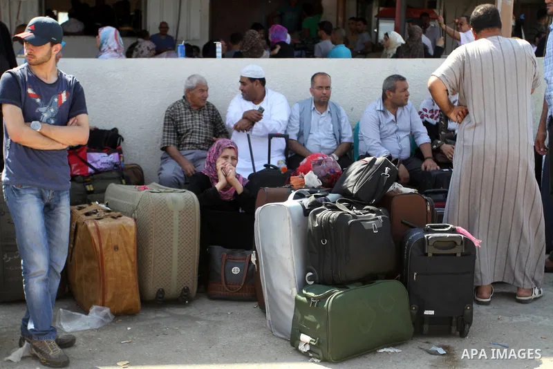 Palestinians gather at the Rafah border crossing in the southern Gaza Strip as they wait for permission to enter Egypt on August 20, 2015. Gunmen in Egypt boarded a bus carrying Palestinians from Cairo to Gaza and seized...