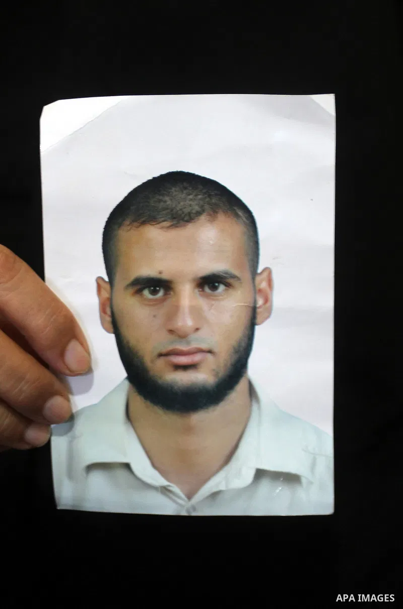 The mother of Yasser Zannoun, 27, holds his picture at their house in Rafah in the southern Gaza Strip, on August 20, 2015. Zannoun is one of four Palestinians were abducted in Egypt's Sinai Peninsula on Wednesday after...