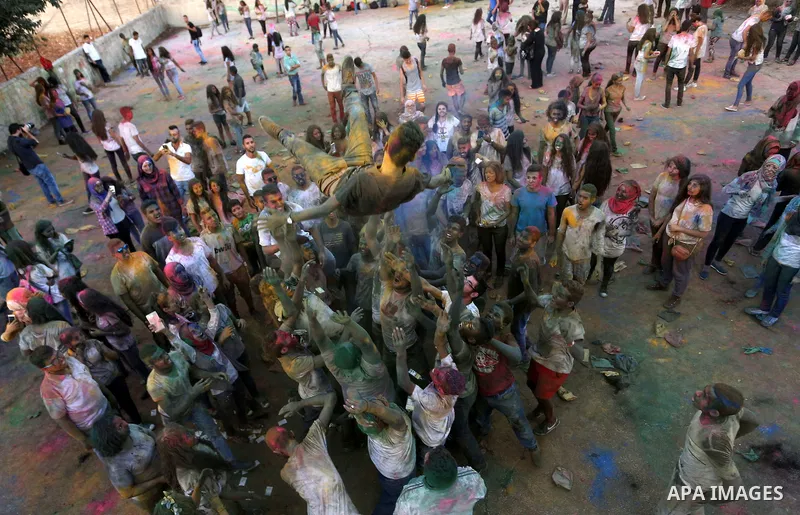 Palestinian youths take part in the festival of colour battle in the West Bank city of Ramallah on August 20, 2015. Photo by Shadi Hatem