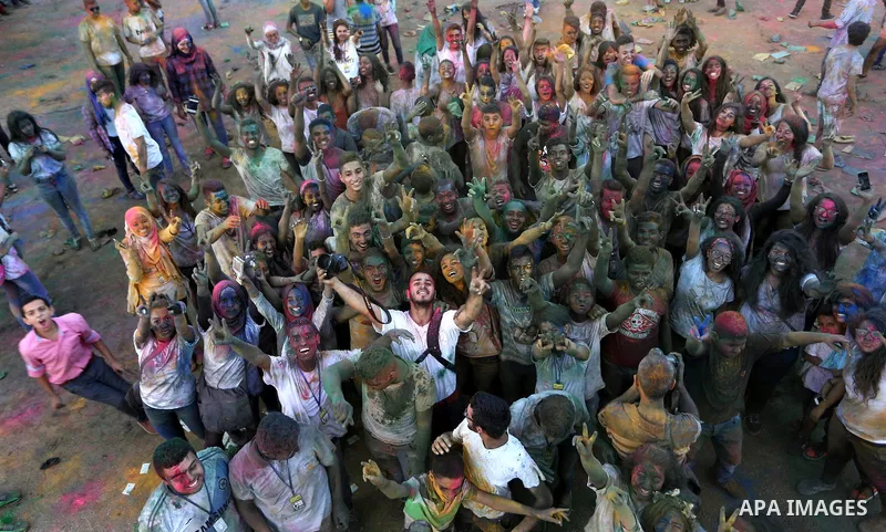 Palestinian youths take part in the festival of colour battle in the West Bank city of Ramallah on August 20, 2015. Photo by Shadi Hatem