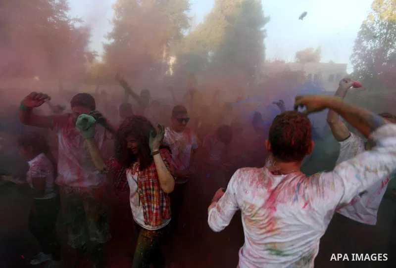 Palestinian youths take part in the festival of colour battle in the West Bank city of Ramallah on August 20, 2015. Photo by Shadi Hatem
