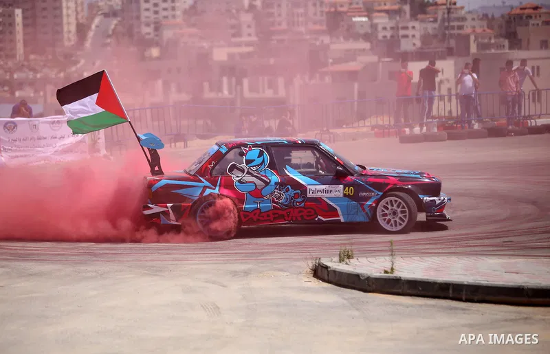 A Palestinian driver competes in a local car race organised by the Palestinian Motor Sport and Motorcycle Federation (PMSMF) in the West Bank city of Ramallah on August 21, 2015. Photo by Shadi Hatem