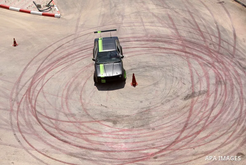 A Palestinian driver competes in a local car race organised by the Palestinian Motor Sport and Motorcycle Federation (PMSMF) in the West Bank city of Ramallah on August 21, 2015. Photo by Shadi Hatem