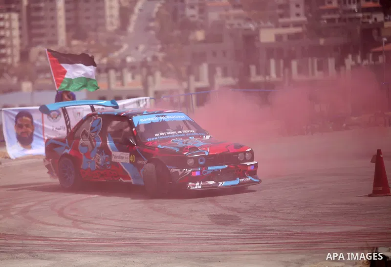 A Palestinian driver competes in a local car race organised by the Palestinian Motor Sport and Motorcycle Federation (PMSMF) in the West Bank city of Ramallah on August 21, 2015. Photo by Shadi Hatem