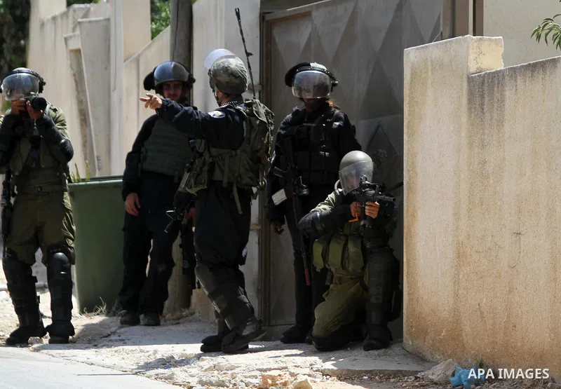 Israeli security forces take position during clashes with Palestinian protesters following a demonstration against the expropriation of Palestinian land by Israel in the village of Kfar Qaddum, near Nablus in the occupie...