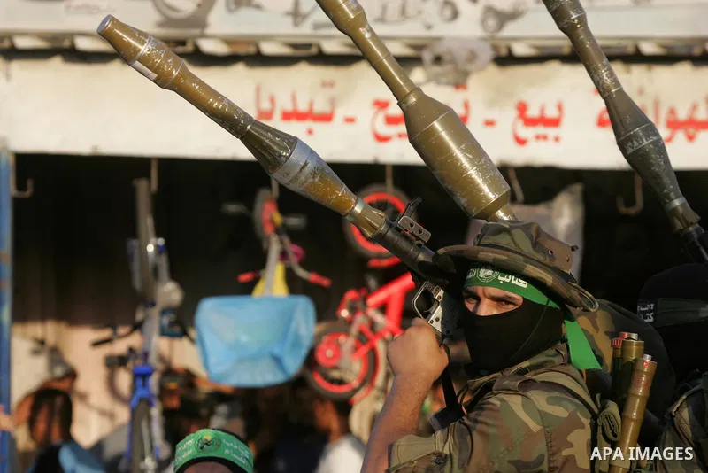 Palestinian members of the al-Qassam Brigades, the armed wing of the Hamas movement, take part in a military parade marking the first anniversary of the killing of Hamas's military commanders Mohammed Abu Shamala and Rae...