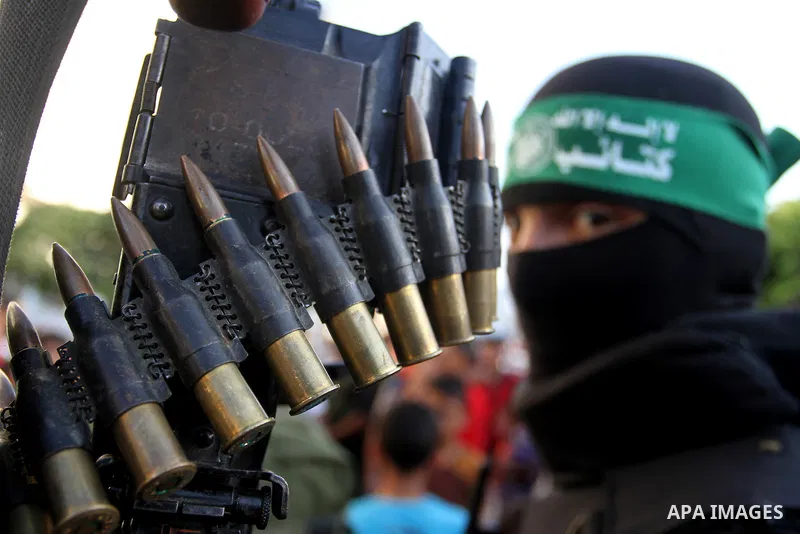 A Palestinian member of the al-Qassam Brigades, the armed wing of the Hamas movement, takes part in a military parade marking the first anniversary of the killing of Hamas's military commanders Mohammed Abu Shamala and R...