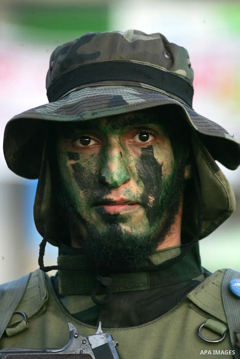 A Palestinian member of the al-Qassam Brigades, the armed wing of the Hamas movement, takes part in a military parade marking the first anniversary of the killing of Hamas's military commanders Mohammed Abu Shamala and R...