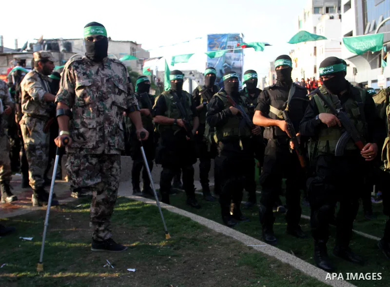 Palestinian members of the al-Qassam Brigades, the armed wing of the Hamas movement, take part in a military parade marking the first anniversary of the killing of Hamas's military commanders Mohammed Abu Shamala and Rae...
