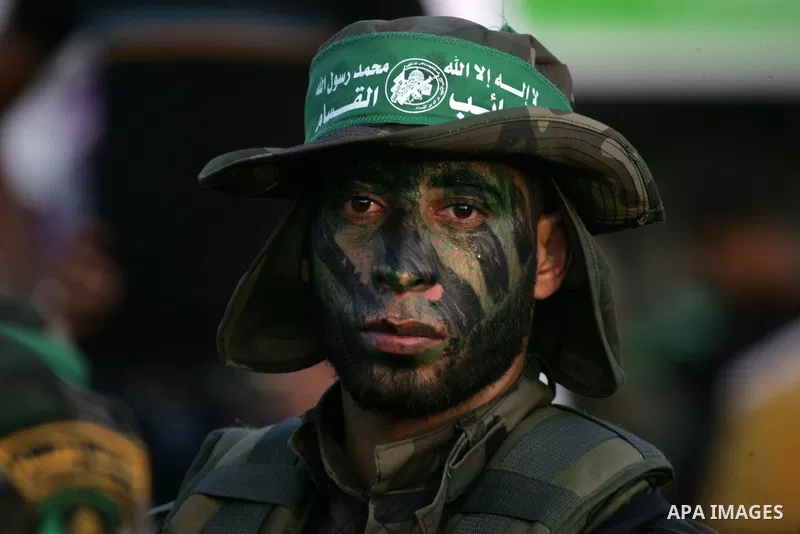 A Palestinian member of the al-Qassam Brigades, the armed wing of the Hamas movement, takes part in a military parade marking the first anniversary of the killing of Hamas's military commanders Mohammed Abu Shamala and R...