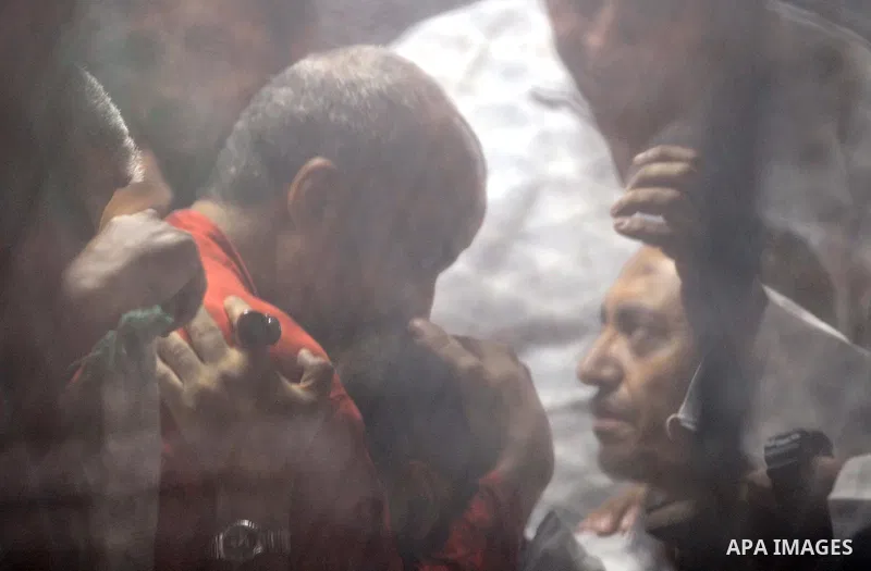 Egyptian Muslim Brotherhood, Mohamed el-Beltagy sits behind the defendant's cage as he attends his trial, in a courtroom in Torah prison, southern Cairo, Egypt, Saturday, Aug. 22, 2015. The court sentenced Muslim Brother...