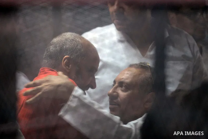 Egyptian Muslim Brotherhood, Mohamed el-Beltagy sits behind the defendant's cage as he attends his trial, in a courtroom in Torah prison, southern Cairo, Egypt, Saturday, Aug. 22, 2015. The court sentenced Muslim Brother...