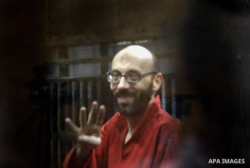 An Egyptian Muslim Brotherhood defendant sits behind the bars during his trial, along with ousted Islamist president Mohamed Morsi (unseen) in Cairo on August 22, 2015. The Cairo court resumed hearing evidence in the so-...