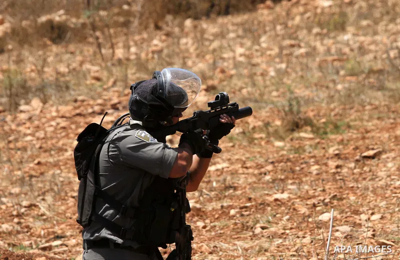 A member of Israeli security forces takes position during clashes with Palestinian protesters following the attack by settlers at the West Bank village of Qasra near Nablus, 22 August 2015. Ghassan Daghlas, who monitors...