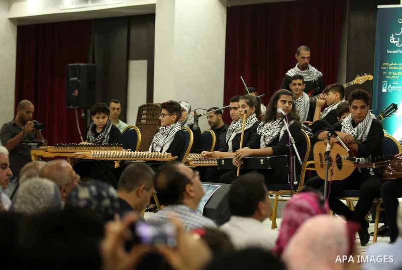 Palestinian members of musical band from "Edward Said National Conservatory of Music" perform in a festival of "Sea and Freedom" in Gaza city on August 22, 2015. Photo by Ashraf Amra
