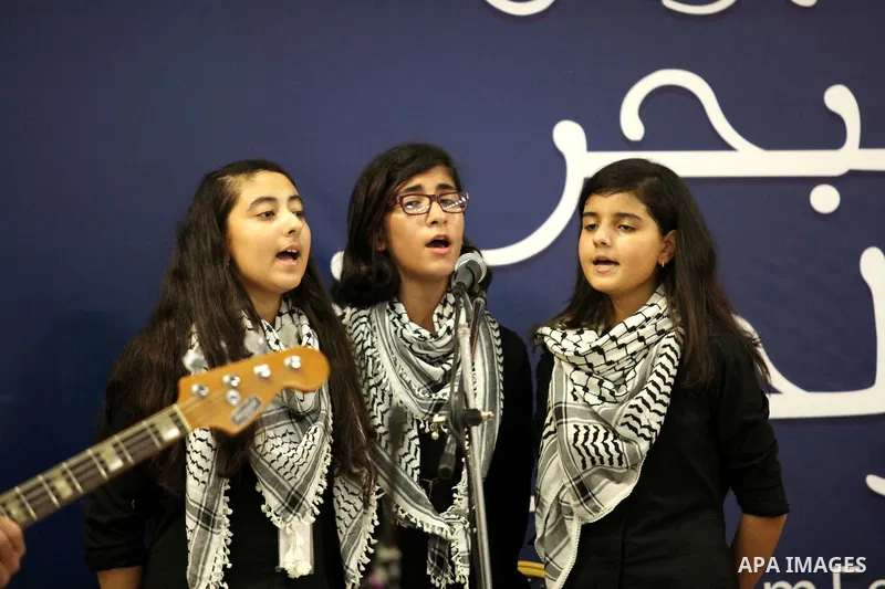 Palestinian members of musical band from "Edward Said National Conservatory of Music" perform in a festival of "Sea and Freedom" in Gaza city on August 22, 2015. Photo by Ashraf Amra