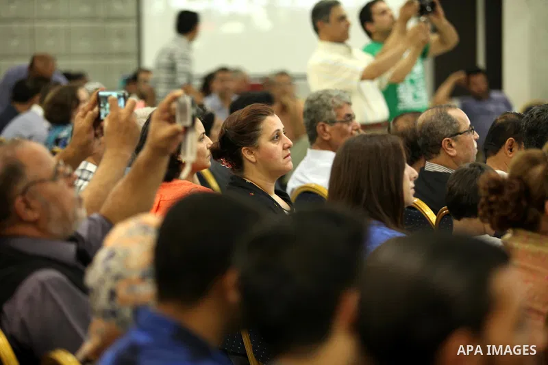 Palestinians watch as members of musical band from "Edward Said National Conservatory of Music" perform in a festival of "Sea and Freedom" in Gaza city on August 22, 2015. Photo by Ashraf Amra