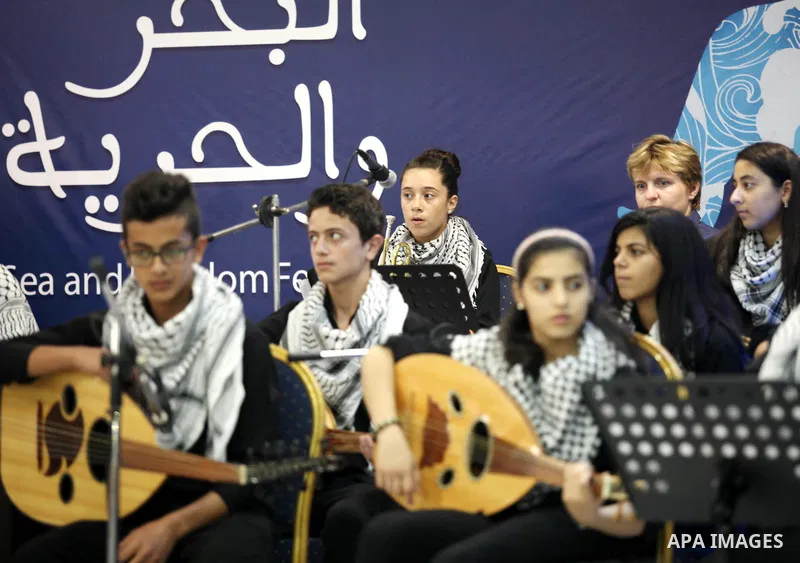 Palestinian members of musical band from "Edward Said National Conservatory of Music" perform in a festival of "Sea and Freedom" in Gaza city on August 22, 2015. Photo by Ashraf Amra