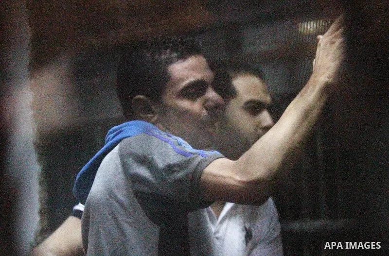 Egyptian defendants wait behind bars for the verdict in their retrial over a 2012 stadium riot in the canal city of Port Said on August 23, 2015 at the police academy on the outskirts of the capital Cairo. Seven defendan...