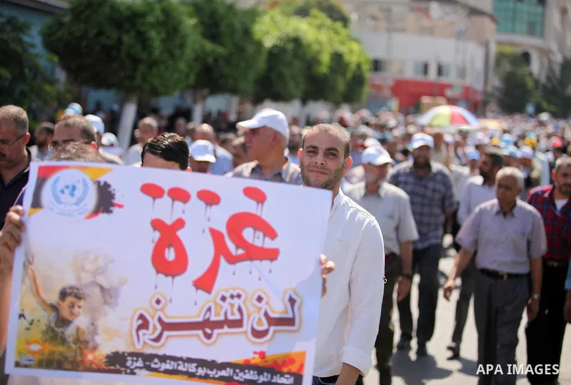 Palestinian employees of the United Nations hold placards during a protest against the reduction of educational programs given by the United Nations Relief and Works Agency (UNRWA) on August 24, 2015 outside the UNESCO h...