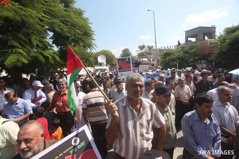 Palestinian employees of the United Nations hold placards during a protest against the reduction of educational programs given by the United Nations Relief and Works Agency (UNRWA) on August 24, 2015 outside the UNESCO h...