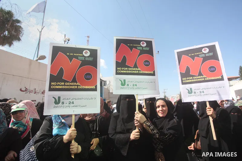 Palestinian employees of the United Nations hold placards during a protest against the reduction of educational programs given by the United Nations Relief and Works Agency (UNRWA) on August 24, 2015 outside the UNESCO h...