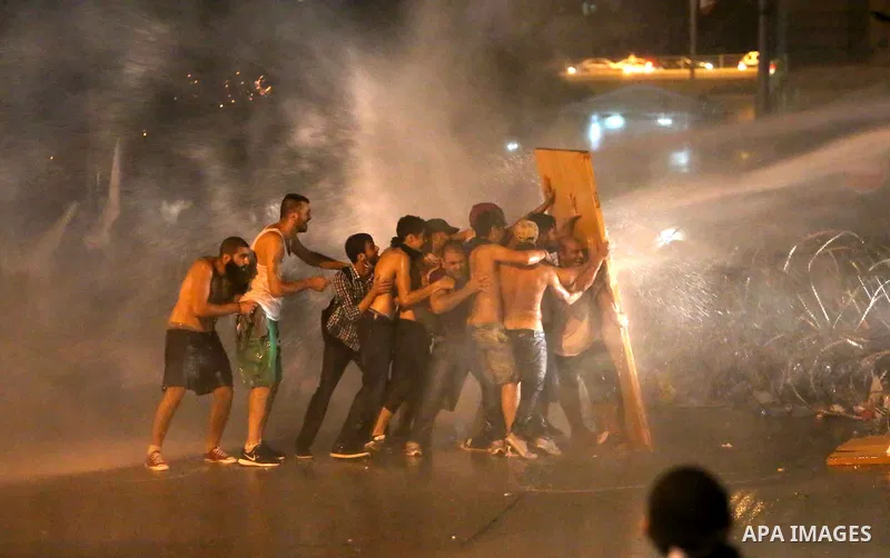 Lebanese riot police use water cannons to disperse protesters during a demonstration, organized by "You Stink" campaign, to protest against the ongoing country's trash crisis in the capital Beirut on August 23, 2015. Dem...
