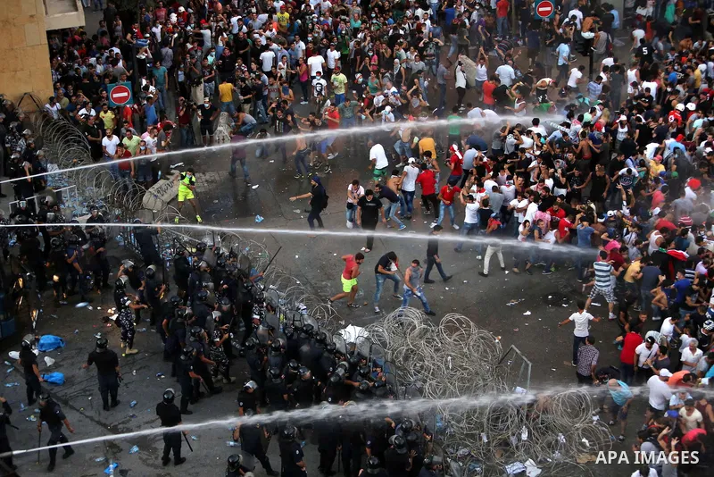 Lebanese riot police use water cannons to disperse protesters during a demonstration, organized by "You Stink" campaign, to protest against the ongoing country's trash crisis in the capital Beirut on August 23, 2015. Dem...