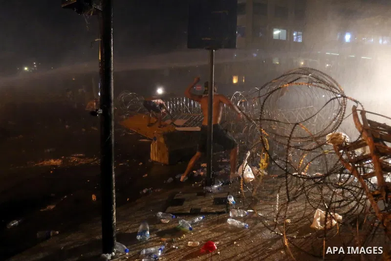 Lebanese riot police use water cannons to disperse protesters during a demonstration, organized by "You Stink" campaign, to protest against the ongoing country's trash crisis in the capital Beirut on August 23, 2015. Dem...