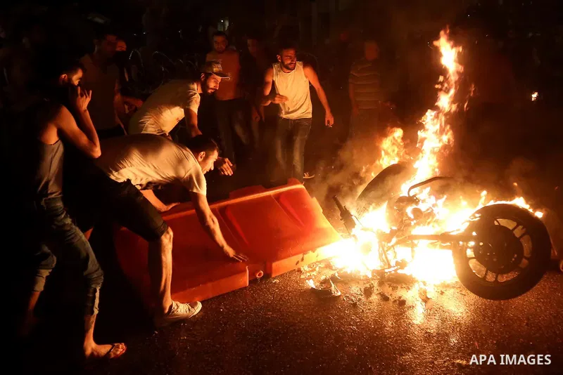 Lebanese protesters set a police motorcycle on fire during clashes with riot police following a demonstration, organized by "You Stink" campaign, to protest against the ongoing country's trash crisis in the capital Beiru...