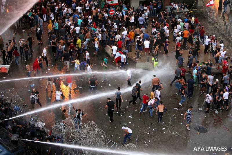 Lebanese riot police use water cannons to disperse protesters during a demonstration, organized by "You Stink" campaign, to protest against the ongoing country's trash crisis in the capital Beirut on August 23, 2015. Dem...