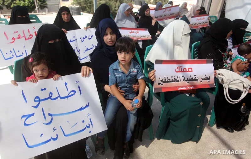 Palestinian families of abductees hold banners during a protest demanding released of four Palestinians were abducted in Egypt's Sinai Peninsula on Wednesday after the bus they were on was stopped by unidentified gunmen,...