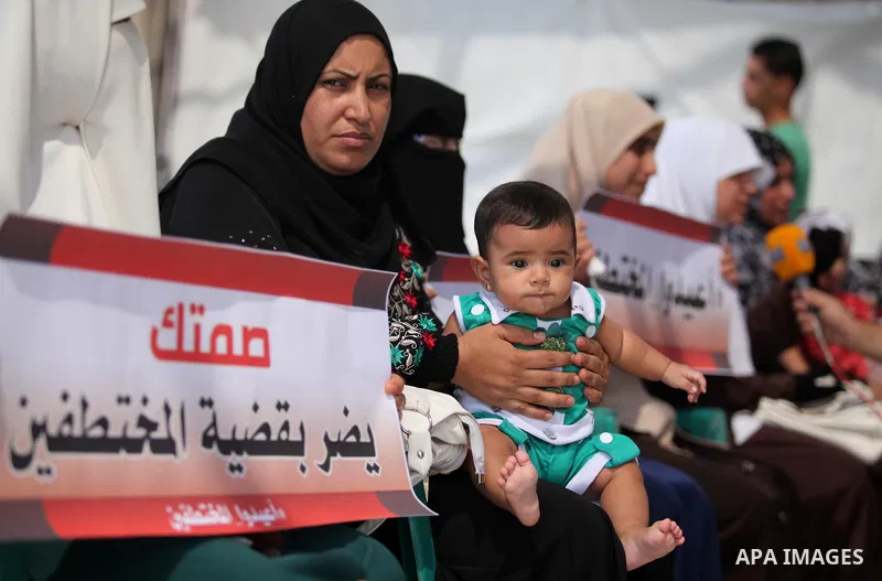 Palestinian families of abductees hold banners during a protest demanding released of four Palestinians were abducted in Egypt's Sinai Peninsula on Wednesday after the bus they were on was stopped by unidentified gunmen,...