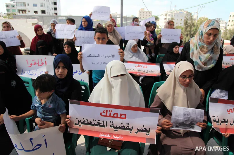 Palestinian families of abductees hold banners during a protest demanding released of four Palestinians were abducted in Egypt's Sinai Peninsula on Wednesday after the bus they were on was stopped by unidentified gunmen,...
