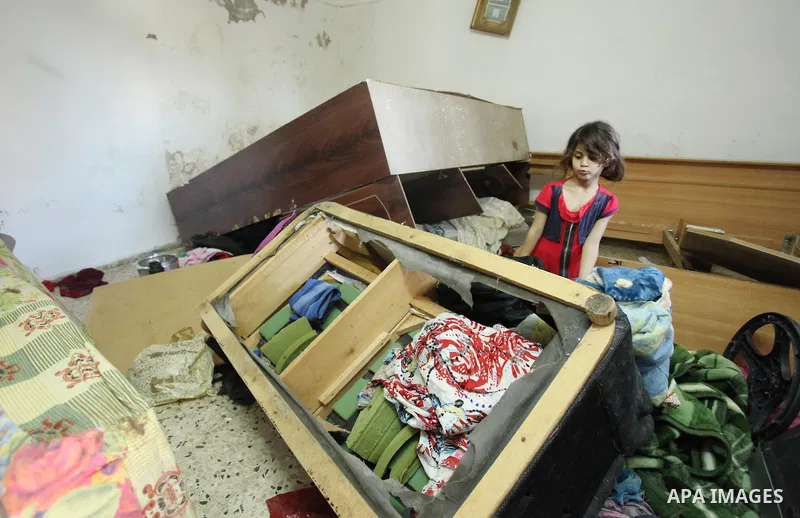 Palestinians inspect their damaged house by the Israeli army, in the West Bank city, on August 26, 2015. Israeli forces detained 31 Palestinians in predawn detention raids across the occupied West Bank Wednesday, the Isr...