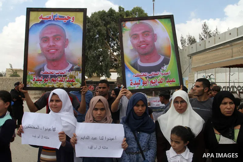 Families of Palestinians who were abducted of by gunmen is Egypt's Sinai's northern region, take part in a demonstration calling for the release at the Rafah border crossing with Egypt in the southern Gaza Strip, on Augu...