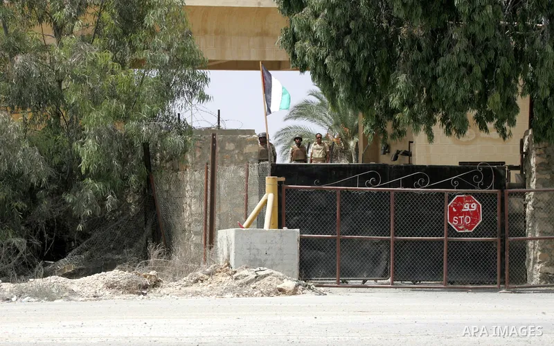 Egyptian soldiers stand guard during a protest by families of Palestinian men who were abducted of by gunmen is Egypt's Sinai's northern region, at the Rafah border crossing between the Gaza Strip and Egypt on August 26,...