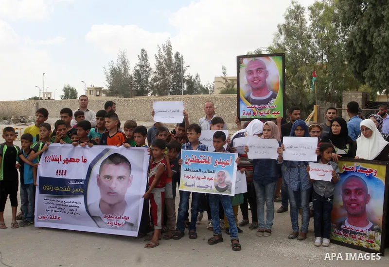 Families of Palestinians who were abducted of by gunmen is Egypt's Sinai's northern region, take part in a demonstration calling for the release at the Rafah border crossing with Egypt in the southern Gaza Strip, on Augu...