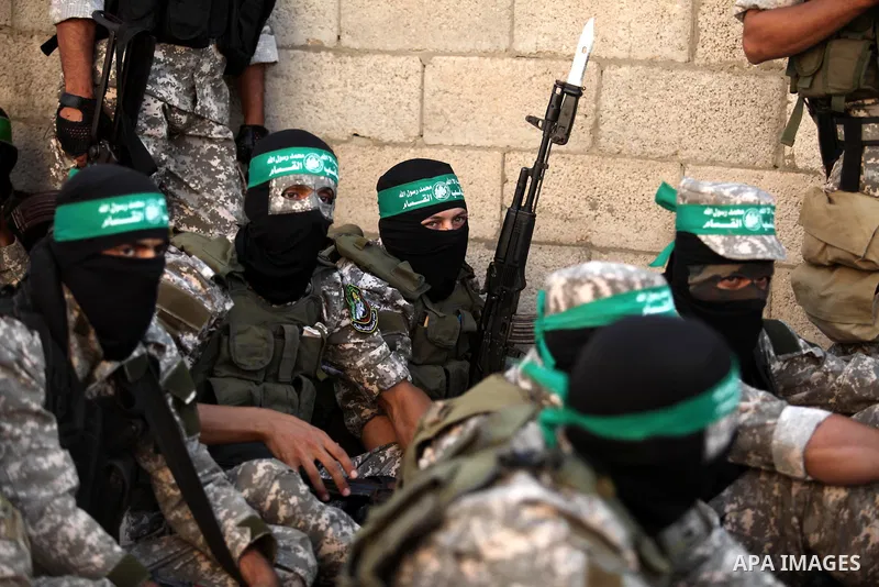 Palestinian militants of the Ezzedine al-Qassam Brigades, Hamas' armed wing, take part in a military parade in Gaza city on August 26, 2015. Photo by Ashraf Amra