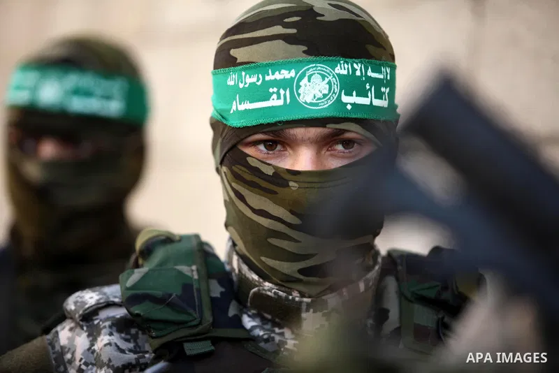 Palestinian militants of the Ezzedine al-Qassam Brigades, Hamas' armed wing, take part in a military parade in Gaza city on August 26, 2015. Photo by Ashraf Amra
