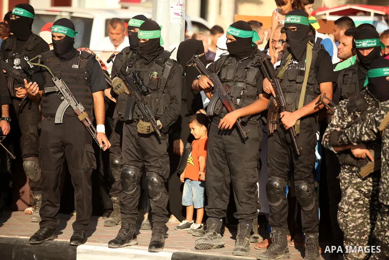 Palestinian militants of the Ezzedine al-Qassam Brigades, Hamas' armed wing, take part in a military parade in Gaza city on August 26, 2015. Photo by Ashraf Amra