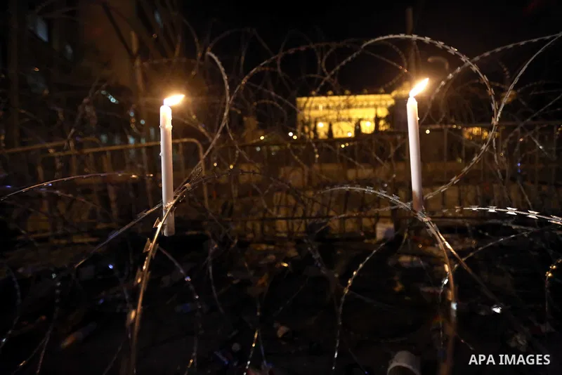 Candles are light on barbed wire during a vigil outside the seat of the government for the protesters injured in recent clashes with police, in the capital Beirut on August 26, 2015. Since August 22, people have gathered...