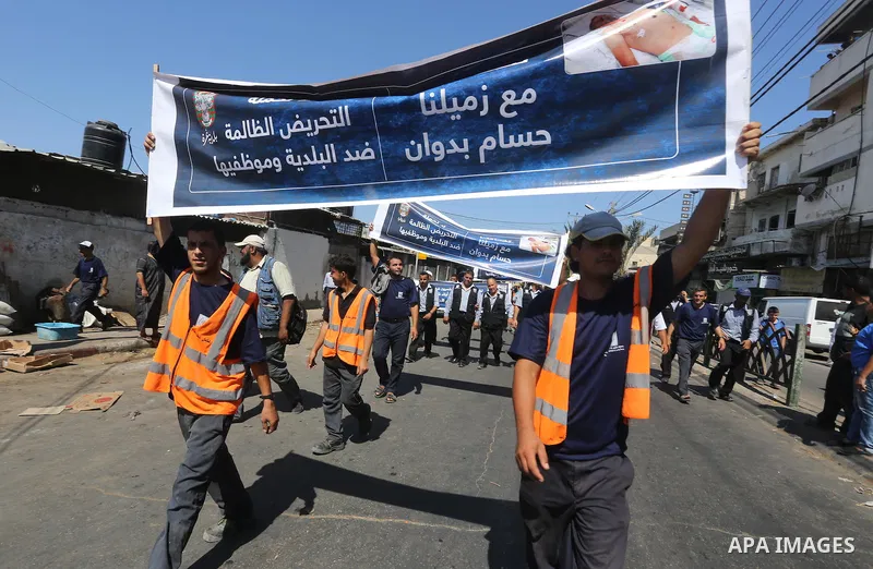 Palestinian employees of the Municipality take part in a protest against the attack on their colleague, in Gaza city, on August 29, 2015. Photo by Mohammed Asad