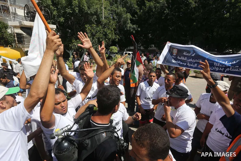 Palestinian employees of the Municipality take part in a protest against the attack on their colleague, in Gaza city, on August 29, 2015. Photo by Mohammed Asad