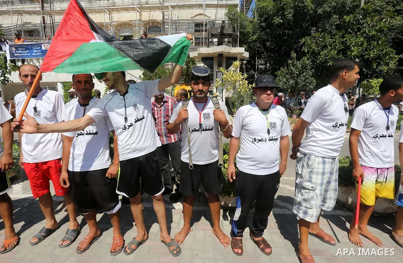 Palestinian employees of the Municipality take part in a protest against the attack on their colleague, in Gaza city, on August 29, 2015. Photo by Mohammed Asad
