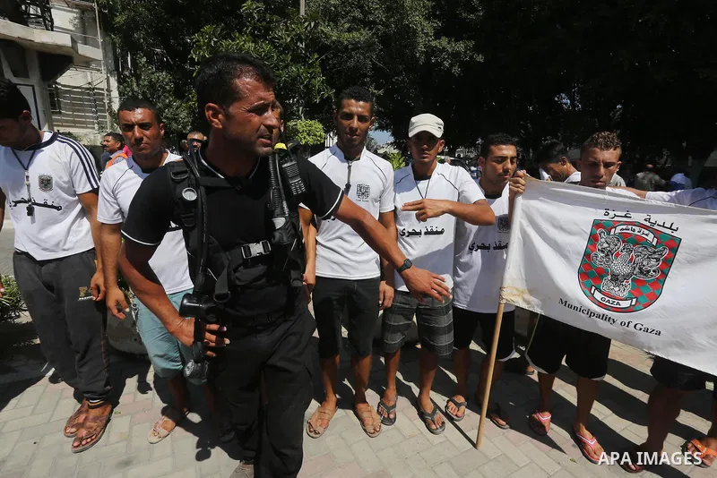 Palestinian employees of the Municipality take part in a protest against the attack on their colleague, in Gaza city, on August 29, 2015. Photo by Mohammed Asad